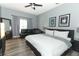 Cozy bedroom features hardwood floors, a comfortable bed, and plenty of natural light at 2545 Azzurra Ln, Ocoee, FL 34761