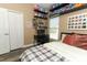 Bedroom with wood floors, a desk, and white closet doors at 2545 Azzurra Ln, Ocoee, FL 34761