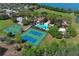 Aerial view featuring pool, tennis court, basketball court, clubhouse and scenic pond in well-maintained condition at 2545 Azzurra Ln, Ocoee, FL 34761