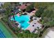 Aerial view of community pool with brick patio, seating and shade trees near community clubhouse at 2545 Azzurra Ln, Ocoee, FL 34761