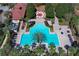 Aerial view of large community pool with palm trees and outdoor seating areas near the clubhouse at 2545 Azzurra Ln, Ocoee, FL 34761