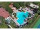 Community pool view showing lounge seating, palm trees, and community clubhouse nearby at 2545 Azzurra Ln, Ocoee, FL 34761