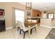Cozy dining space with tile flooring, a modern chandelier, and an adjacent kitchen area at 2545 Azzurra Ln, Ocoee, FL 34761
