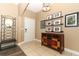 Inviting foyer featuring a decorative mirror, console table, and tiled flooring at 2545 Azzurra Ln, Ocoee, FL 34761