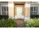 A welcoming front entrance with sidelight windows, brick walkway, and trimmed hedges creating curb appeal at 2545 Azzurra Ln, Ocoee, FL 34761