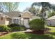 Well-maintained front yard with lush landscaping, mulch beds, and a brick walkway leading to the front door at 2545 Azzurra Ln, Ocoee, FL 34761