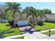 Inviting single-Gathering home with a spacious lawn, beautiful landscaping, and a brick-paved driveway at 2545 Azzurra Ln, Ocoee, FL 34761