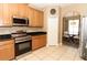 Well-equipped kitchen featuring stainless steel appliances, tile flooring, and generous storage at 2545 Azzurra Ln, Ocoee, FL 34761