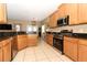 Spacious kitchen with stainless steel appliances, granite countertops and wooden cabinetry at 2545 Azzurra Ln, Ocoee, FL 34761