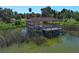 Charming covered dock provides a scenic spot for enjoying lake views and waterfront activities at 2545 Azzurra Ln, Ocoee, FL 34761