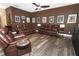 Large living room with hardwood floors, comfortable leather furniture and dark accent wall at 2545 Azzurra Ln, Ocoee, FL 34761