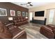 Comfortable living room featuring a large TV, hardwood floors, and stylish decor at 2545 Azzurra Ln, Ocoee, FL 34761