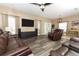 Bright living room with hardwood floors, a ceiling fan, and an open layout to the dining area at 2545 Azzurra Ln, Ocoee, FL 34761