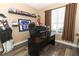 Office space with a dark desk and chair, window and brown curtains, wood floor, and sports decor at 2545 Azzurra Ln, Ocoee, FL 34761