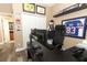 Office space with a dark desk and chair, window and brown curtains, wood floor, and sports decor at 2545 Azzurra Ln, Ocoee, FL 34761