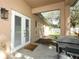 Enclosed patio area with a grill, concrete flooring, and access to the yard at 2545 Azzurra Ln, Ocoee, FL 34761
