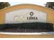 A stone community sign reading ALERIA, surrounded by lush greenery at 2545 Azzurra Ln, Ocoee, FL 34761