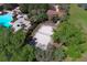 Community sand volleyball court adjacent to pool with shade trees and seating in a landscaped area at 2545 Azzurra Ln, Ocoee, FL 34761