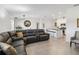 Open-concept living room showcasing a large sectional sofa and connection to the eat-in kitchen at 26101 Bristleleaf Ct, Leesburg, FL 34748