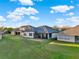 Aerial view showing a home's backyard, screened lanai, and lawn at 2680 Lookout Ln, Kissimmee, FL 34746