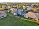 Aerial view of a residential neighborhood with well-maintained homes, green lawns, and a peaceful community setting at 2680 Lookout Ln, Kissimmee, FL 34746