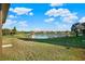 Expansive backyard with serene water views, docks, and lush greenery for outdoor relaxation and recreation at 2680 Lookout Ln, Kissimmee, FL 34746