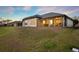 Exterior of home with screened patio and large backyard at 2680 Lookout Ln, Kissimmee, FL 34746