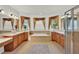 Luxurious primary bathroom features dual sinks, a soaking tub, and multiple windows with wood-style blinds at 2680 Lookout Ln, Kissimmee, FL 34746