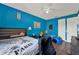 Blue bedroom featuring hardwood floors, ceiling fan, and two twin beds at 2680 Lookout Ln, Kissimmee, FL 34746