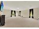 Spacious bonus room with carpeting, neutral paint, black curtains, and ample natural light at 2680 Lookout Ln, Kissimmee, FL 34746