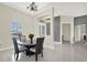 Dining area featuring an elegant chandelier with sightlines to the front door and other living spaces at 2680 Lookout Ln, Kissimmee, FL 34746