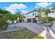 Stunning two-story home showcasing a three-car garage, lush landscaping, and a spacious paved driveway at 2680 Lookout Ln, Kissimmee, FL 34746