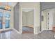 Inviting foyer with stylish tile flooring, a modern light fixture, and an arched doorway at 2680 Lookout Ln, Kissimmee, FL 34746