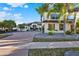 Beautiful two-story home featuring a brick driveway and lush landscaping with palm trees at 2680 Lookout Ln, Kissimmee, FL 34746