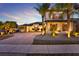 Beautiful two-story home showcasing a brick driveway and lush landscaping with palm trees at 2680 Lookout Ln, Kissimmee, FL 34746