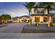 Beautiful two-story home showcasing a brick driveway and lush landscaping with palm trees at 2680 Lookout Ln, Kissimmee, FL 34746