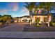 Beautiful two-story home showcasing a brick driveway and lush landscaping with palm trees at 2680 Lookout Ln, Kissimmee, FL 34746