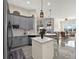 Open kitchen featuring gray cabinets, modern lighting, and a view into the adjacent living space at 2680 Lookout Ln, Kissimmee, FL 34746