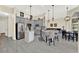 A bright kitchen with gray cabinetry, an island, and stainless steel appliances flowing into an open living space at 2680 Lookout Ln, Kissimmee, FL 34746