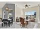 An open living area offers views of the lake, tile flooring, and seamless transitions to the dining space at 2680 Lookout Ln, Kissimmee, FL 34746