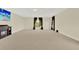 Large living room featuring neutral carpet, fireplace, and two large windows with dark curtains at 2680 Lookout Ln, Kissimmee, FL 34746