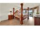 Spacious primary bedroom features a wooden four-poster bed and water views at 2680 Lookout Ln, Kissimmee, FL 34746