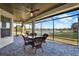Enjoy lake views from this screened lanai with brick floors, ceiling fans, and outdoor dining set at 2680 Lookout Ln, Kissimmee, FL 34746