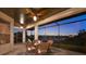 Outdoor dining set on a screened lanai with ceiling fans makes for relaxing evenings at 2680 Lookout Ln, Kissimmee, FL 34746