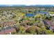 Wide aerial shot of the community featuring a pond, golf course, and residential buildings at 3038 Clubview Dr # Ge, Orlando, FL 32822