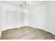 Bedroom features closet with folding doors, neutral paint, and wood-look flooring at 3038 Clubview Dr # Ge, Orlando, FL 32822