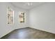 Bright bedroom features wood-look flooring, neutral paint, and natural light from two windows at 3038 Clubview Dr # Ge, Orlando, FL 32822