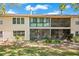 Charming townhouse exterior featuring a screened patio and lush landscaping at 3038 Clubview Dr # Ge, Orlando, FL 32822
