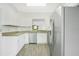 Modern kitchen features stainless steel appliances, white cabinetry and granite countertops at 3038 Clubview Dr # Ge, Orlando, FL 32822