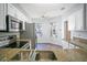 Well-lit kitchen features stainless steel appliances, granite countertops, and modern fixtures at 3038 Clubview Dr # Ge, Orlando, FL 32822